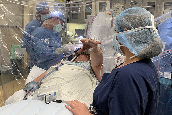 A patient’s tremor is tested in the operating room during DBS surgery.